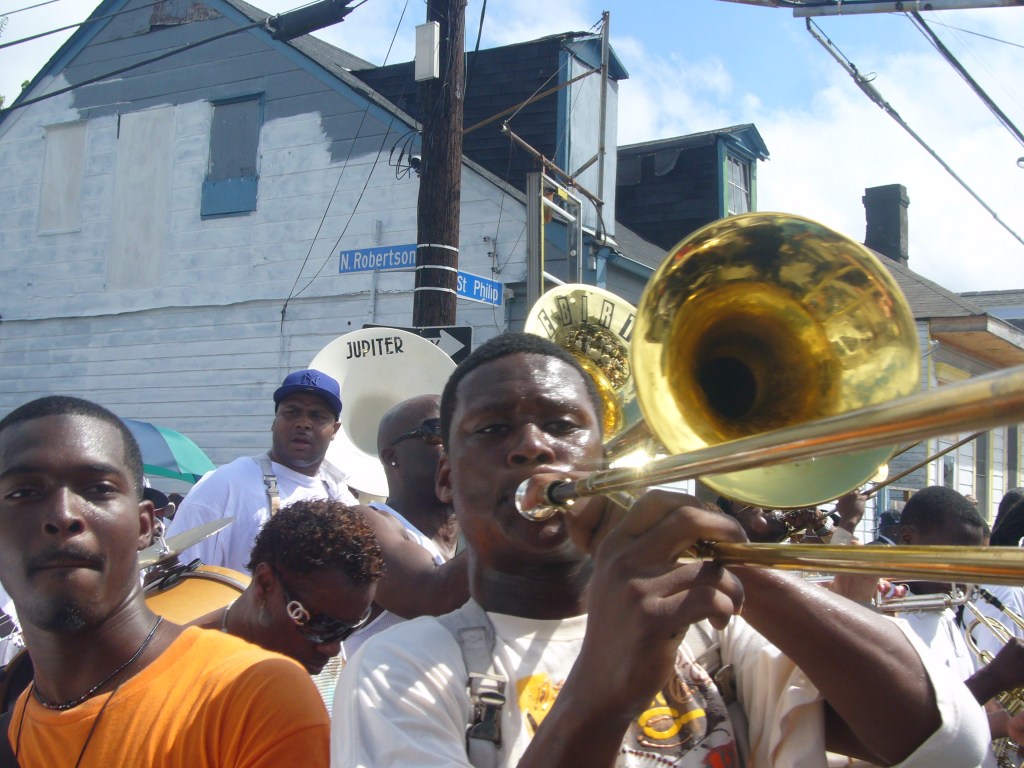 Derrick Tabb plays in the jazz funeral for Kerwin James in October 2007 while marching past the spot he was arrested days earlier.